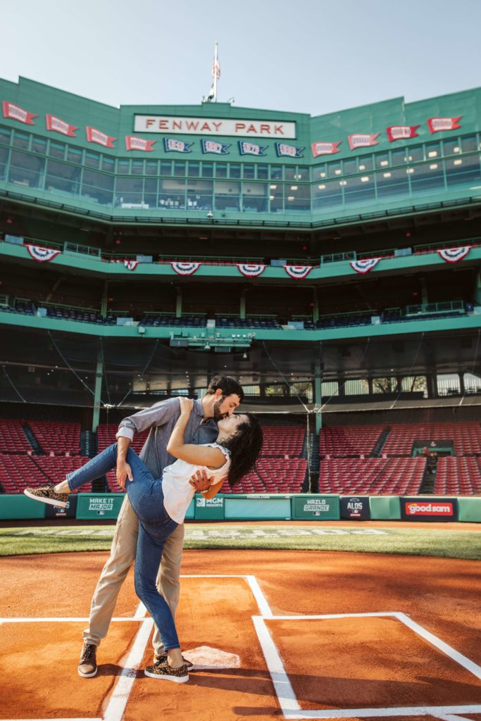 Couple poses at home plate at Fenway during their Boston engagement photos