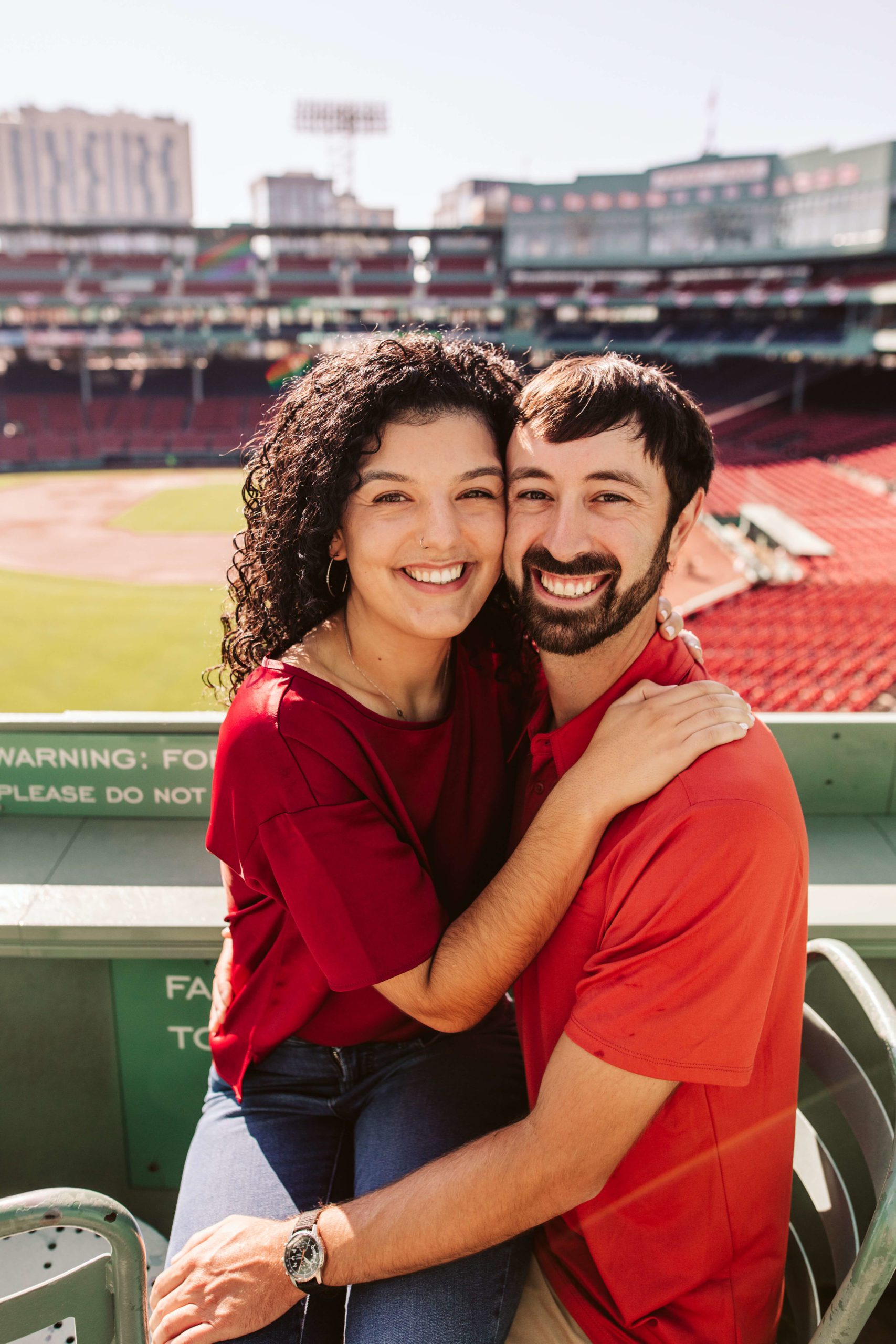 Couple poses at Fenway for their Boston engagement photos